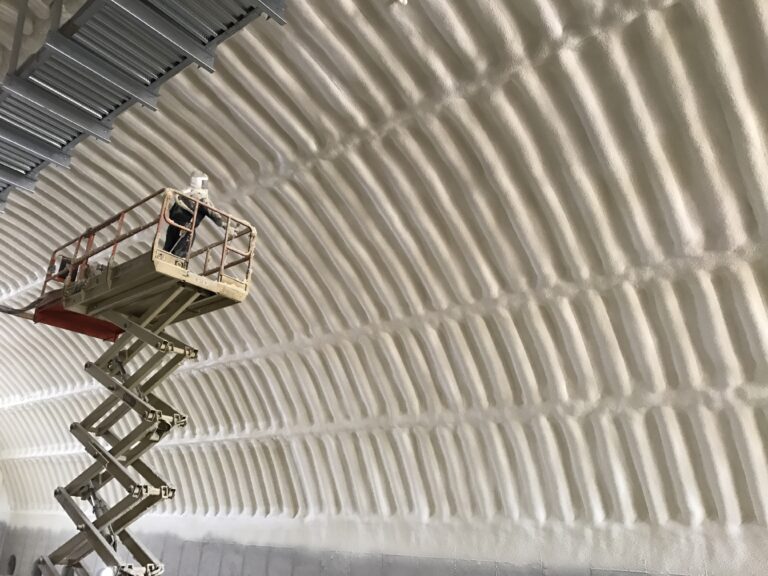 Person on scissor lift spraying foam